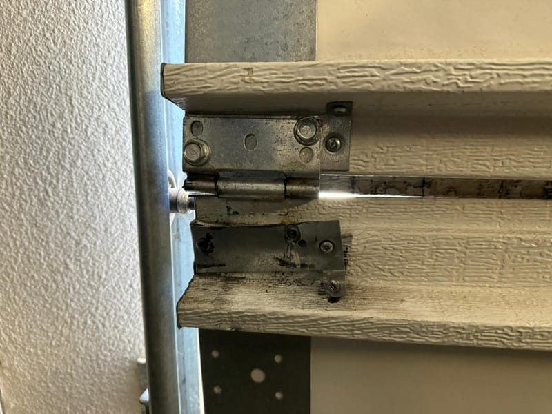 New steel rollers installed on a garage door track